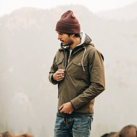 our fit model wearing The Welterweight Winslow in Olive Dry Waxed Canvas—looking left