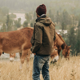 our fit model wearing The Welterweight Winslow in Olive Dry Waxed Canvas—looking out to valley