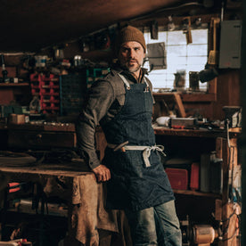 fit model wearing The Work Apron in Cone Mills Selvage, in workshop