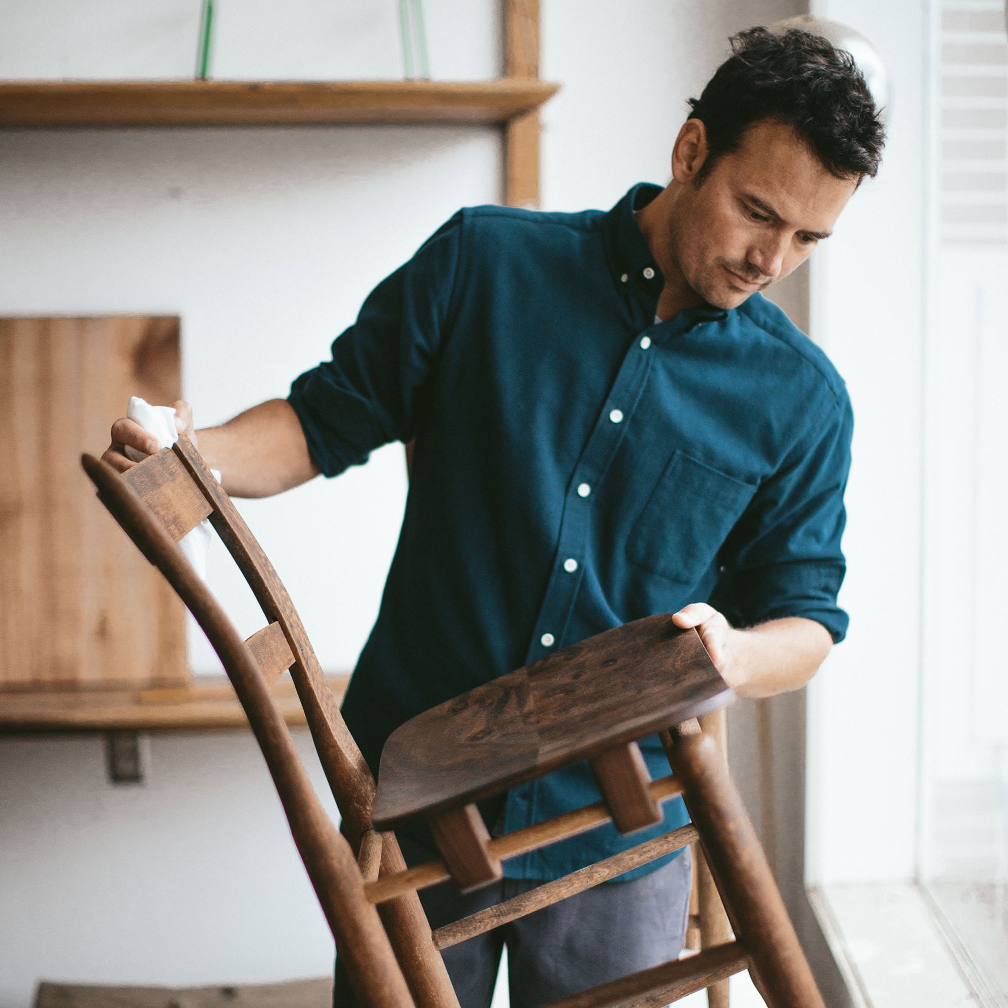 Patric looking over the chair he made, Wovens by Taylor Stitch