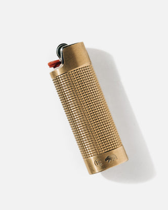 editorial image of The Lighter Sleeve in Brass flatlay