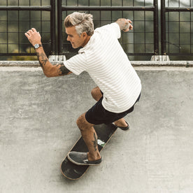 Our fit model skateboarding in The Heavy Bag Tee in Natural Stripe