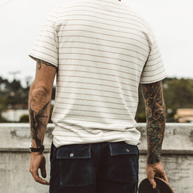 Our fit model skateboarding in The Heavy Bag Tee in Natural Stripe
