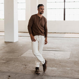 The fit model wearing The Heavy Bag Henley in Fatigue Brown by Taylor Stitch.