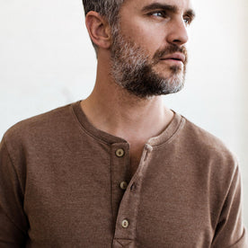 The fit model wearing The Heavy Bag Henley in Fatigue Brown by Taylor Stitch.