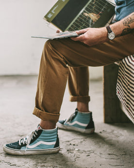 James looking at his records , Pants by Taylor Stitch