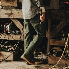 Our fit model wearing The Chore Pant in Dark Olive Tuff Duck from Taylor Stitch.