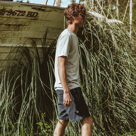 Our fit model walking next to an old boat.