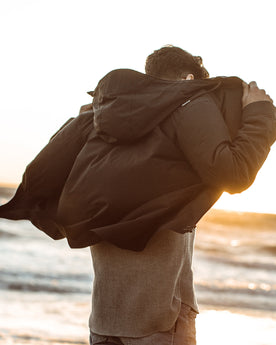 Jonny wearing our jacket next to the shore, Outerwear by Taylor Stitch