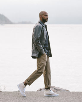 Alex walking along the shore side in the Primrose Jacket, Outerwear by Taylor Stitch