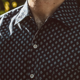 Close shot of our fit model wearing a floral shirt