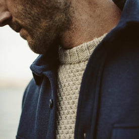 A close up shot of our fit model wearing the Fisherman Sweater