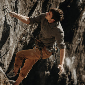 The fit model climbing in the durable Yosemite Shirt in Heather Charcoal