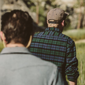 fit model hiking in a field with his friends