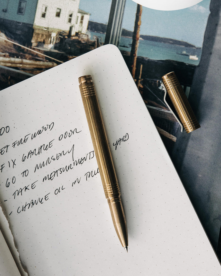material shot of The Pen in Brass on a notebook, Accessories by Taylor Stitch