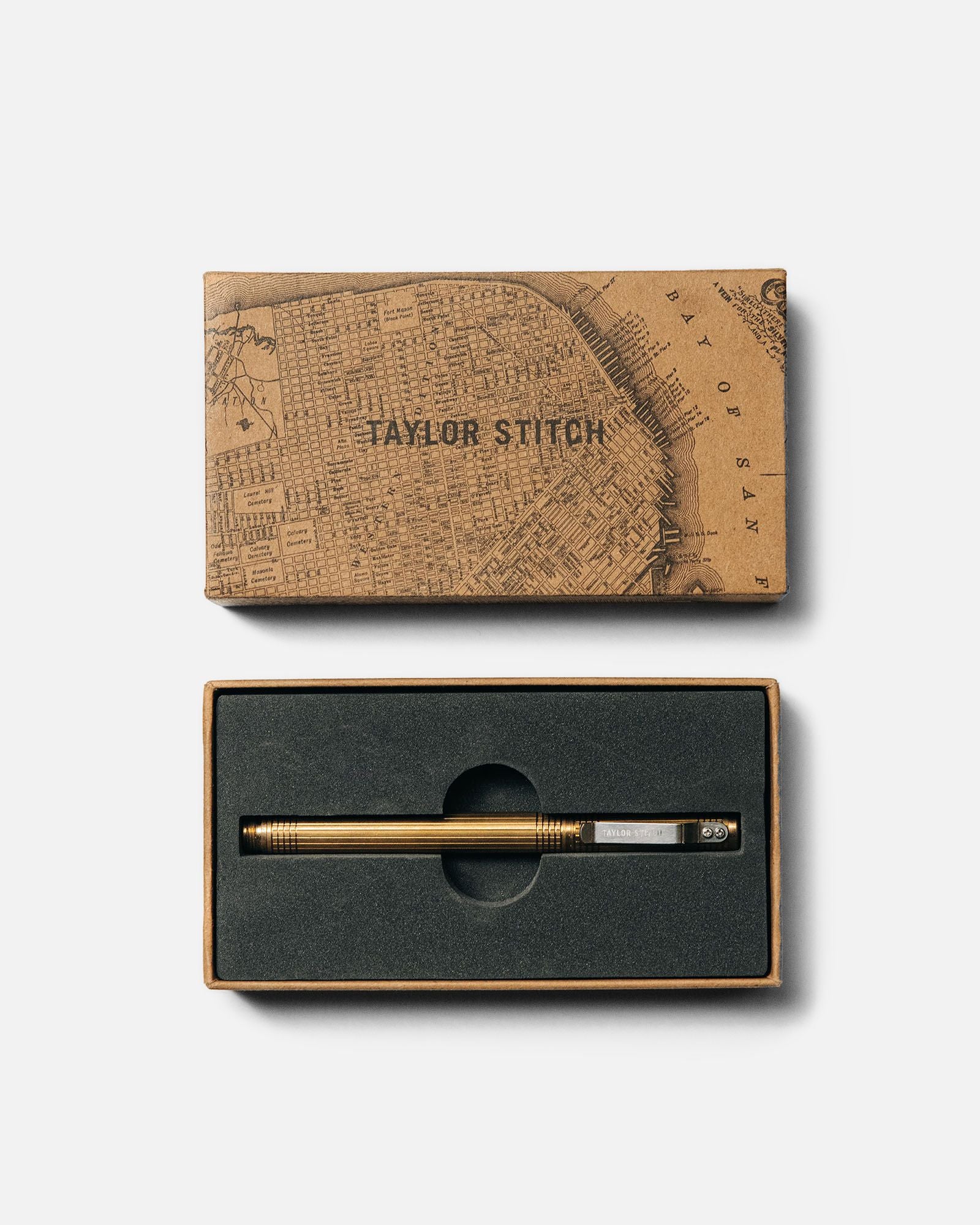 flatlay of The Pen in Brass in a Taylor Stitch gift box