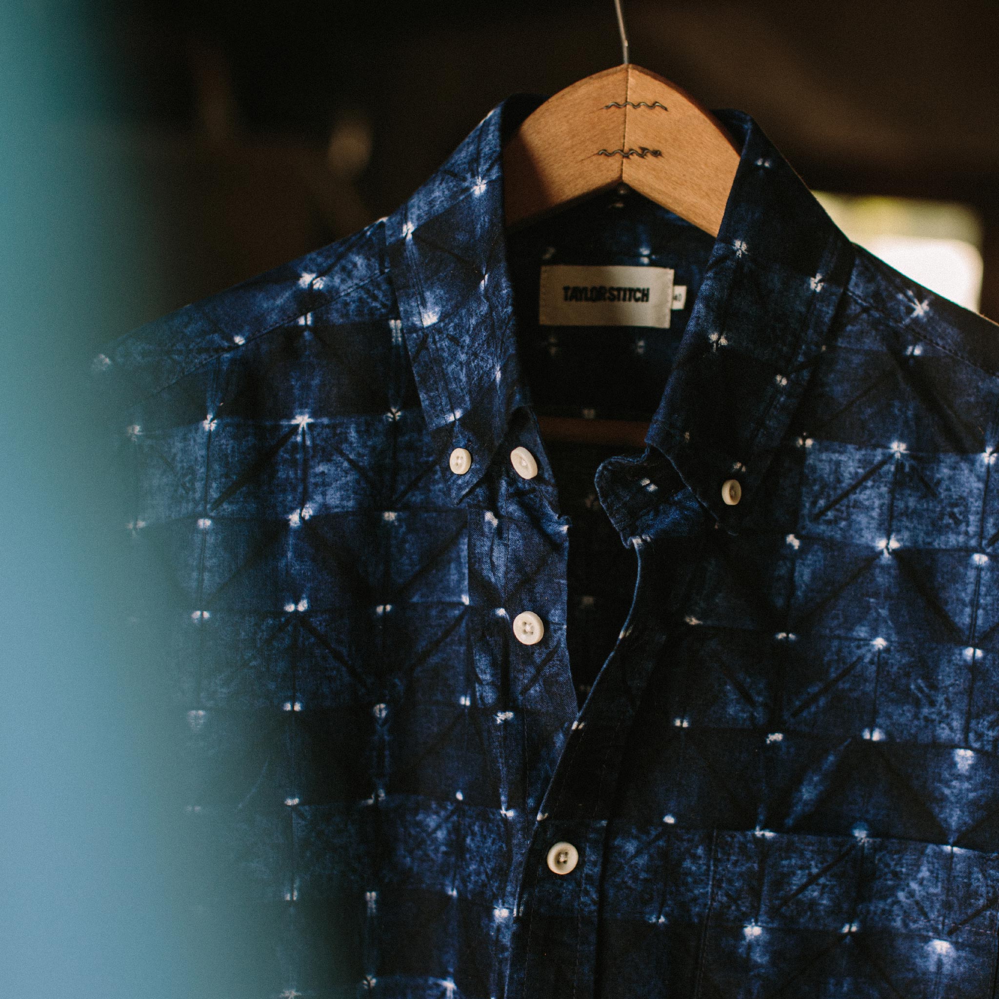 material shot of The Short Sleeve Jack in Deep Navy Geo on a hanger, Wovens by Taylor Stitch