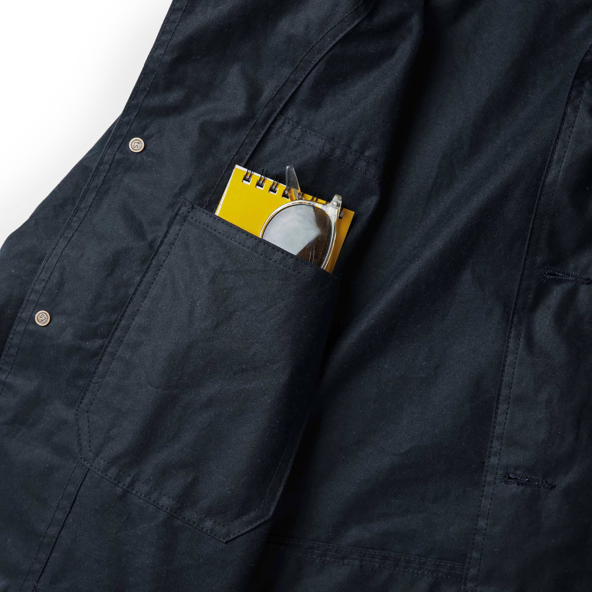 material shot of personal items in inside pocket of The Task Jacket in Waxed Navy, Outerwear by Taylor Stitch