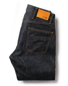 flatlay of The Slim Jean in Natural Indigo Selvage, shown folded from the back, Bottoms by Taylor Stitch