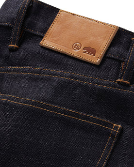 material shot of the logo patch on The Democratic Jean in Kuroki Welterweight Slub, Bottoms by Taylor Stitch