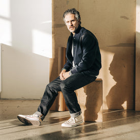 fit model sitting wearing The Slim Jean in Kuroki Welterweight Slub