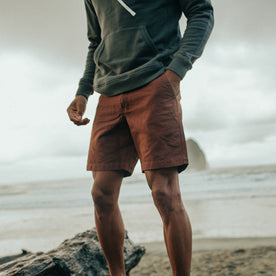fit model standing on the beach in The Morse Short in Russet Linen