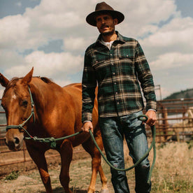 fit model wearing The Ledge Shirt in Deep Sea Plaid with a horse