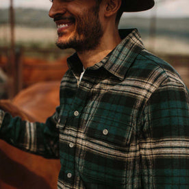 fit model wearing The Ledge Shirt in Deep Sea Plaid smiling on a ranch