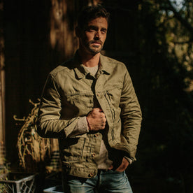 fit model wearing The Ryder Jacket in Yoshiwa Mills Olive outside in a forest