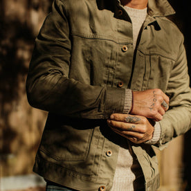 fit model wearing The Ryder Jacket in Yoshiwa Mills Olive playing with cuff