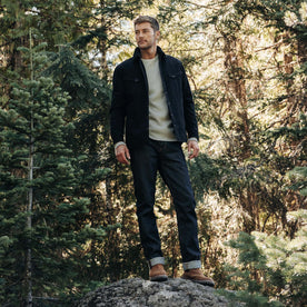 fit model standing on a rock in The Slim Jean in Cone Mills Cordura Denim