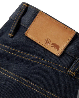 material shot of leather logo patch on The Slim Jean in Cone Mills Cordura Denim, Bottoms by Taylor Stitch