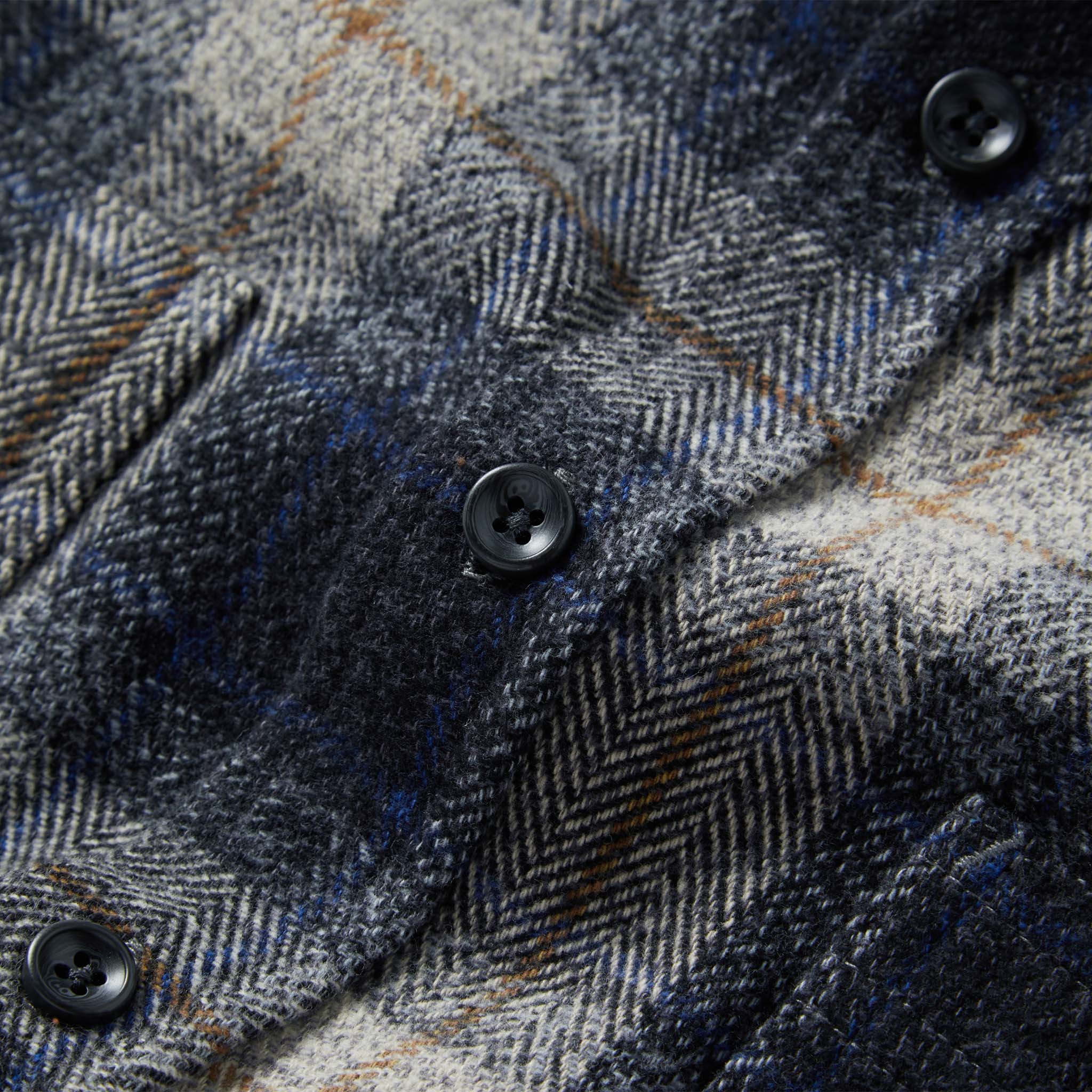 material shot of the buttons on The Utility Shirt in Navy Jaspe Herringbone Plaid, Wovens by Taylor Stitch