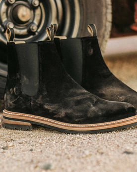 material shot of The Ranch Boot in Coal Weatherproof Suede—next to car, Footwear by Taylor Stitch