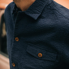 our fit model wearing The Caravan Shirt in Navy Seersucker—cropped shot of chest