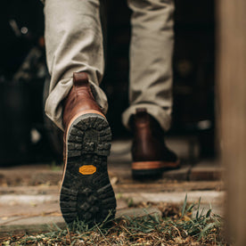 our fit model wearing The Moto Boot in Chocolate Pebble Grain—shot of vibram sole