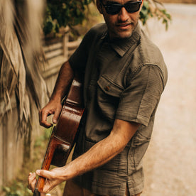 our fit model wearing The Caravan Shirt in Walnut Double Cloth—playing guitar