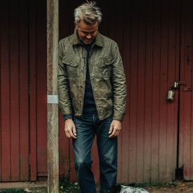 out fit model wearing The Lined Long Haul Jacket in Olive Waxed Canvas