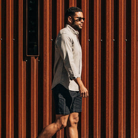 our fit model wearing The Trail Short in Navy Slub Sateen—walking right