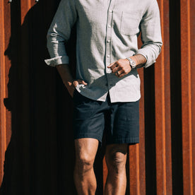 our fit model wearing The Trail Short in Navy Slub Sateen—against a red backdrop