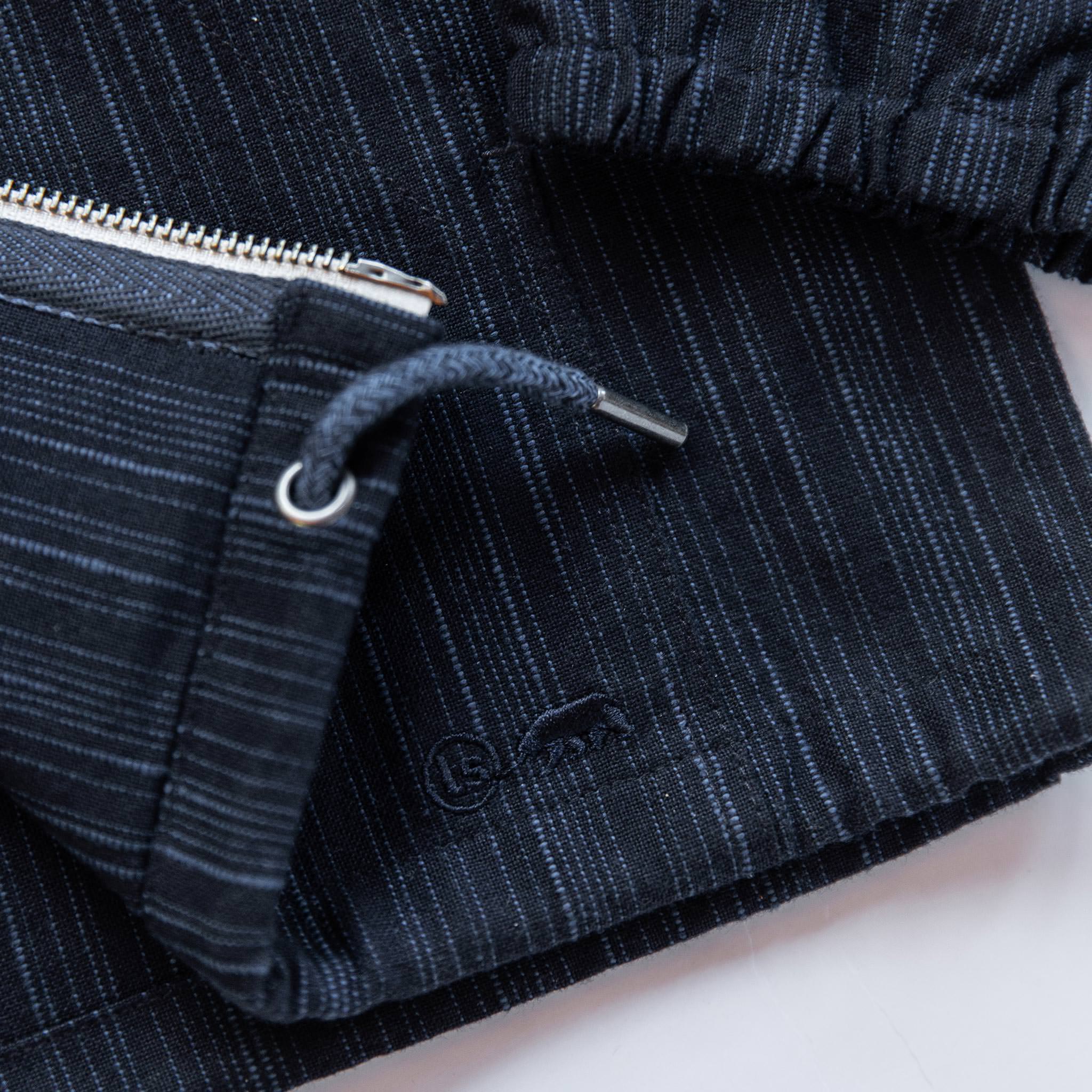 material shot of logo on bottom, Outerwear by Taylor Stitch