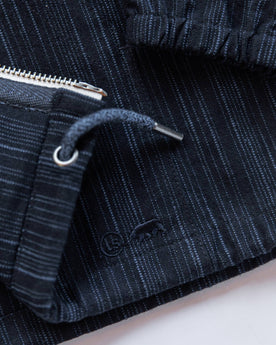 material shot of logo on bottom, Outerwear by Taylor Stitch