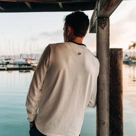 fit model wearing The Heavy Bag Long Sleeve in Natural, back shot looking at marina