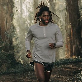 fit model wearing The Shoreline Henley in High Rise, running on trail