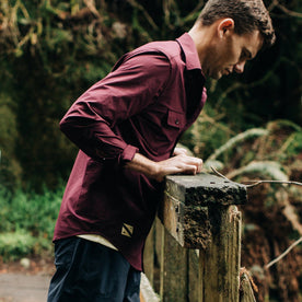 fit model wearing The Over Shirt in Wine, looking into water