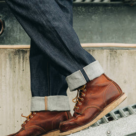 fit model wearing The Democratic Jean in Cone Mills Reserve Selvage, cuffed over boots