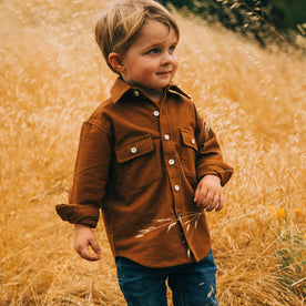 our fit model wearing The Little Yosemite Shirt in Tobacco—hanging out in the field