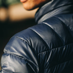 out fit model wearing The Taylor Stitch x Mission Workshop Farallon Jacket in Midnight Blue—shoulder detail shot