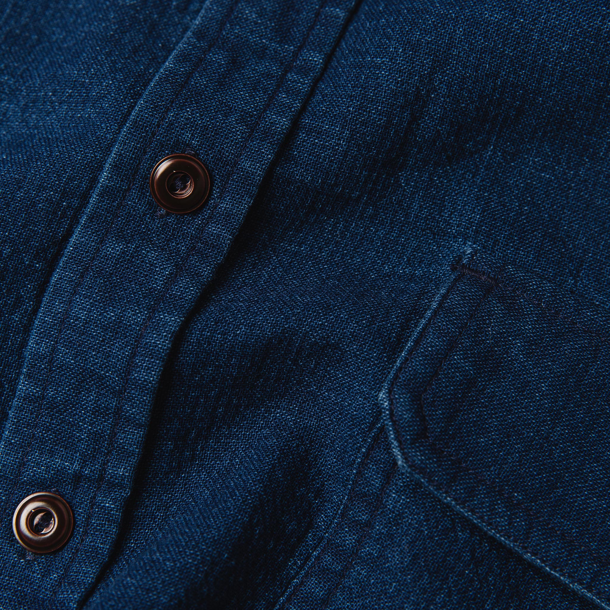 material shot of The Corso Shirt in Indigo Double Cloth close up of the placket with buttons and chest pocket, Wovens by Taylor Stitch