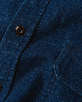 material shot of The Corso Shirt in Indigo Double Cloth close up of the placket with buttons and chest pocket, Wovens by Taylor Stitch